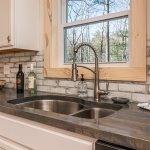 Kitchen Sink window overlooks wooded glen in private backyard